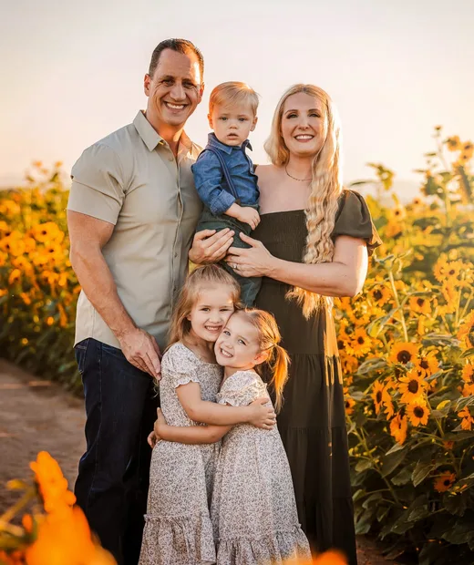 Dr. Lisa Kubik with her husband Chad and their children Olivia, Caroline, and Christian in an Arizona sunflower field